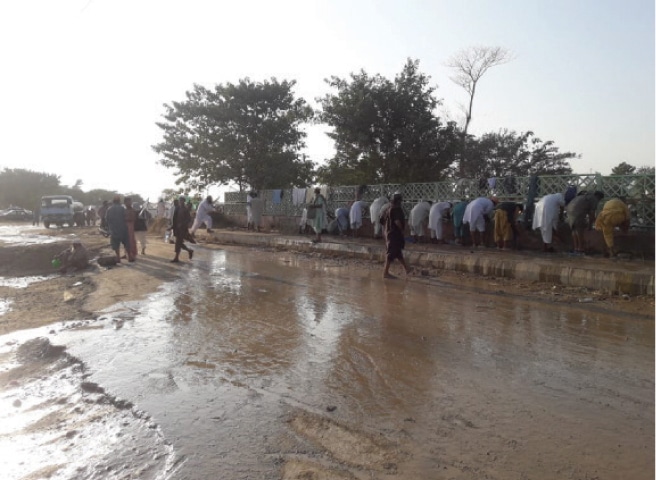 Water stands at the H-9 protest venue and the road adjacent to it.  Photos by Tanveer Shahzad and Kashif Abbasi
