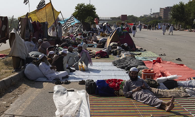 JUI-F supporters camp along the roadside during an anti-government protest in Islamabad on Monday, Nov 4.  AP