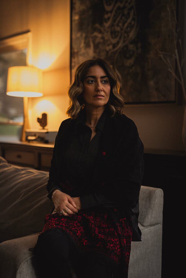 Ghada Elnajjar sitting for a portrait indoors.